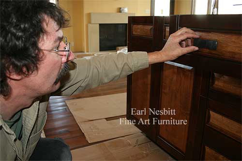 Earl checking drawer pulls on custom made cabinet